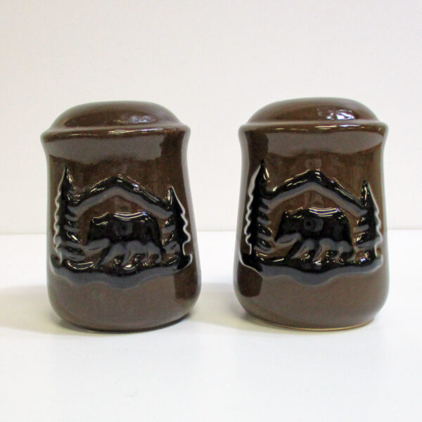 Brown salt and pepper shakers with black bear embossed.