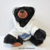 Black bear plush wearing a Minnesota white hoody.