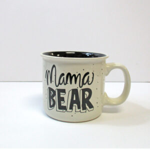 Mama bear cream ceramic mug with black bear image.